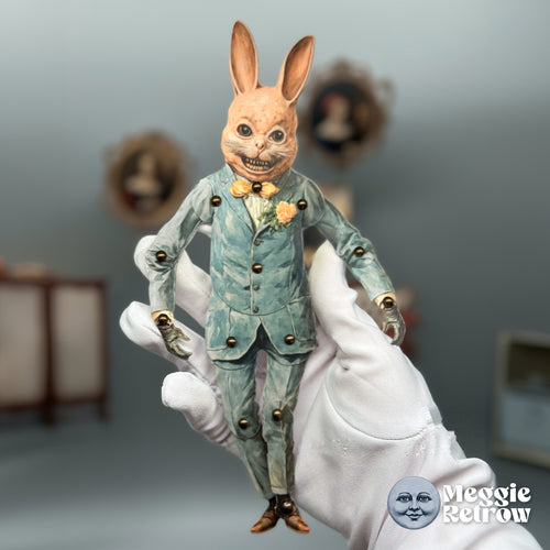 Bucky Rabbit, a printable articulated paper doll. A sharp-toothed grin and a blue suit with a peach flower.