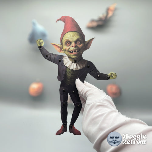 Frightful Fizzle, a printable articulated paper doll. Green skin, a white ruff, and a tall red cap.