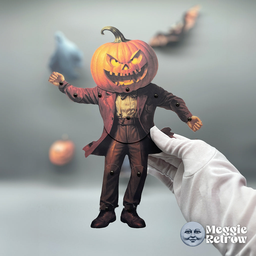 Pumpkin Fiend, a printable articulated paper doll. A carved pumpkin head and a long red coat.