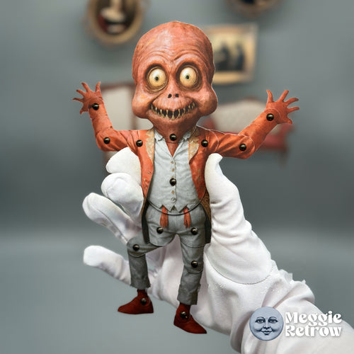 Ghoul, a printable articulated paper doll. Brick-red skin and a red tailcoat over a gray waistcoat.