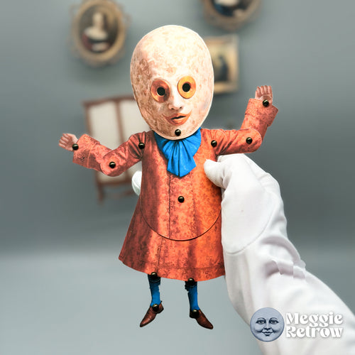 Hidden Howl, a printable articulated paper doll. A speckled egg-shaped head and a rust-orange coat.