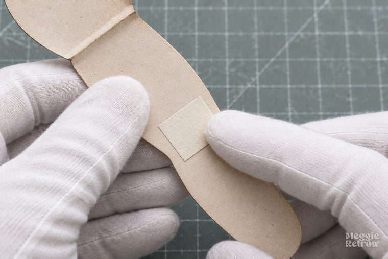 Paper patch glued behind a hole