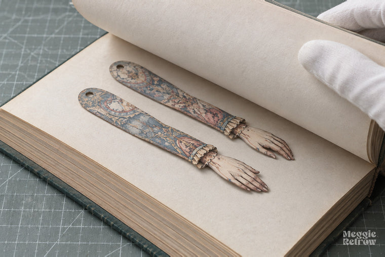 Doll pressed flat inside a book