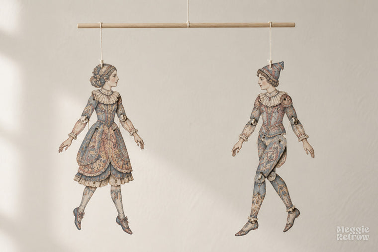 Two dolls balanced on a mobile