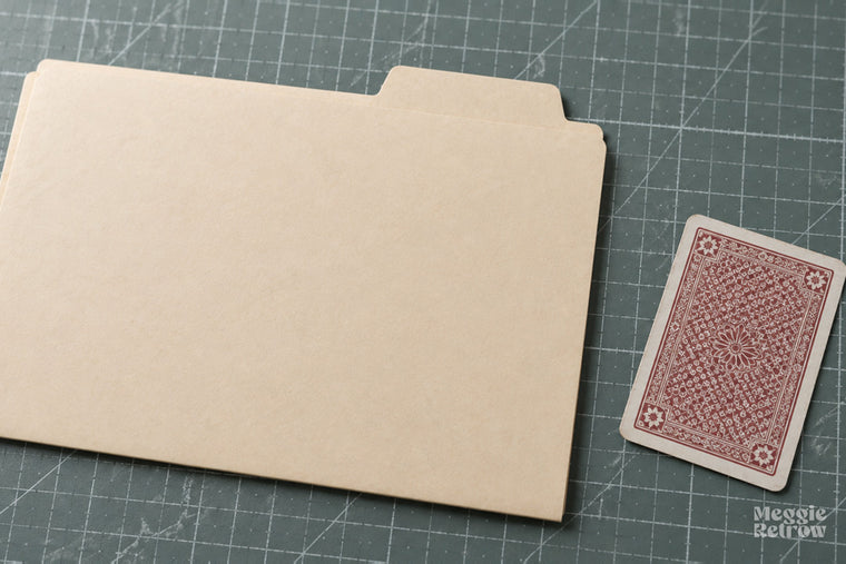Manila folder and a playing card